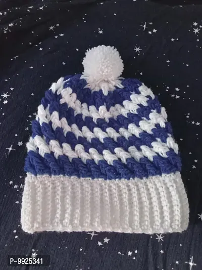 Blue and white woolen baby cap with pom pom