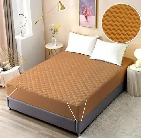 baby care waterproof mattress protector sheet of beige colour with zig zag pattern.