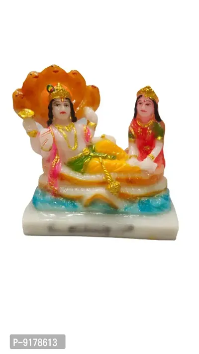 Marble Made Lord Vishnu and Goddess Lakshmi are sitting together  is protecting them.